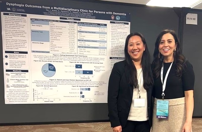 Joanne Yee (left) and Nicole Rogus-Pulia (right) standing in front of a scientific poster.